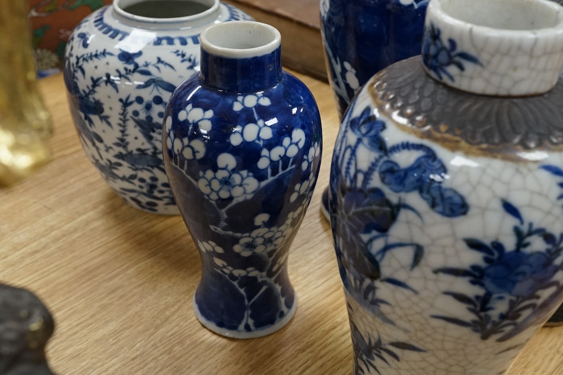 Chinese blue and white porcelain, late 19th century, comprising two prunus vases, two crackle glaze vases and a 'Bird and Flowers' jar, tallest crackle glaze vases 23cm